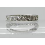 A DIAMOND SET FULL ETERNITY RING mounted in white metal with engraved border, estimate approx