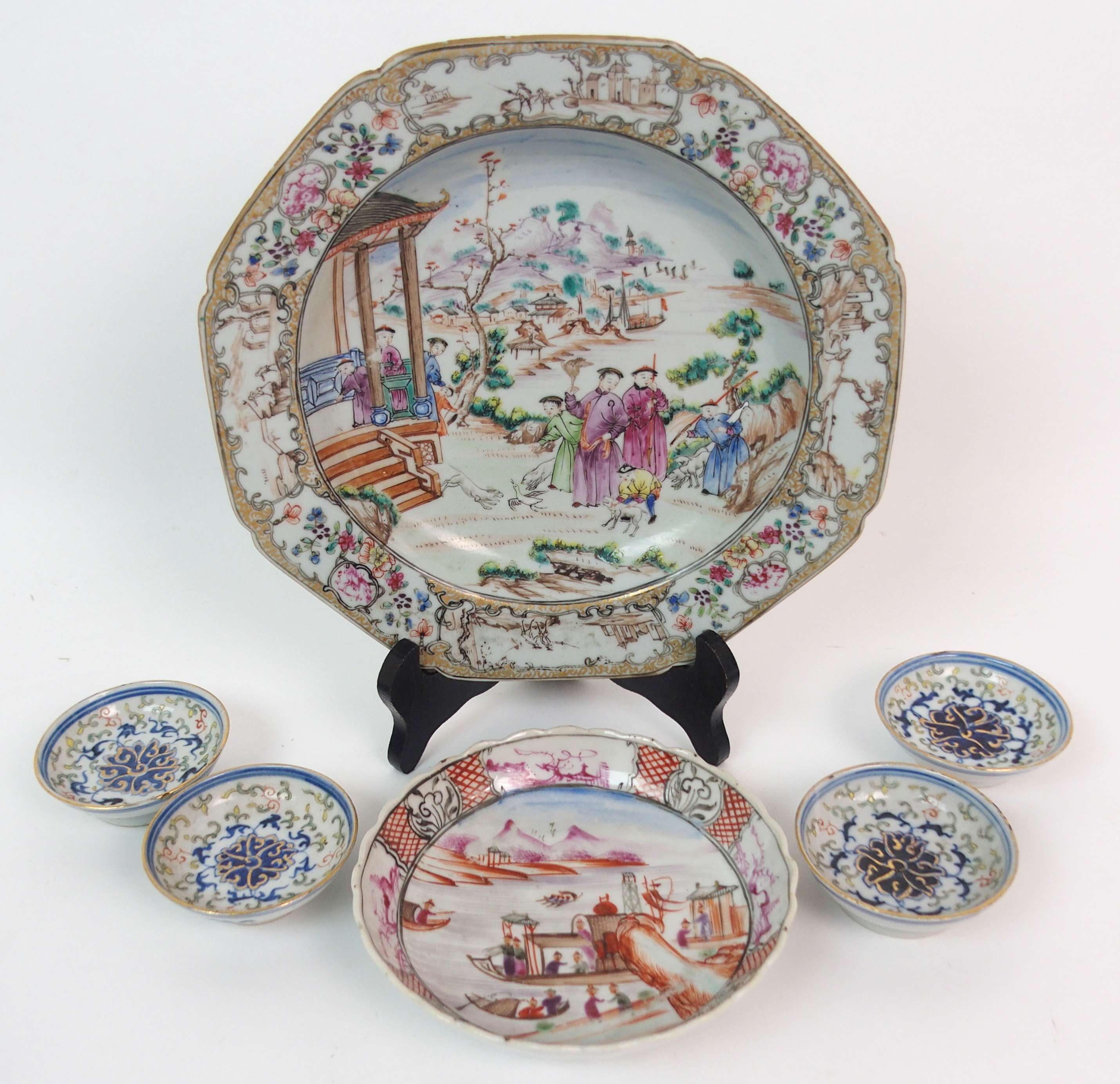 A CHINESE EXPORT SOUP PLATE painted with figures beside a pavilion within a border of landscape