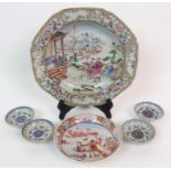 A CHINESE EXPORT SOUP PLATE painted with figures beside a pavilion within a border of landscape