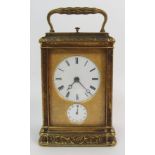 A BRASS CASED REPEATER ALARM CARRIAGE CLOCK the enamelled dial with Roman numerals and with a