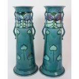 A PAIR OF MINTON SECESSIONIST VASES the tapering turquoise body with applied handles and tubeline