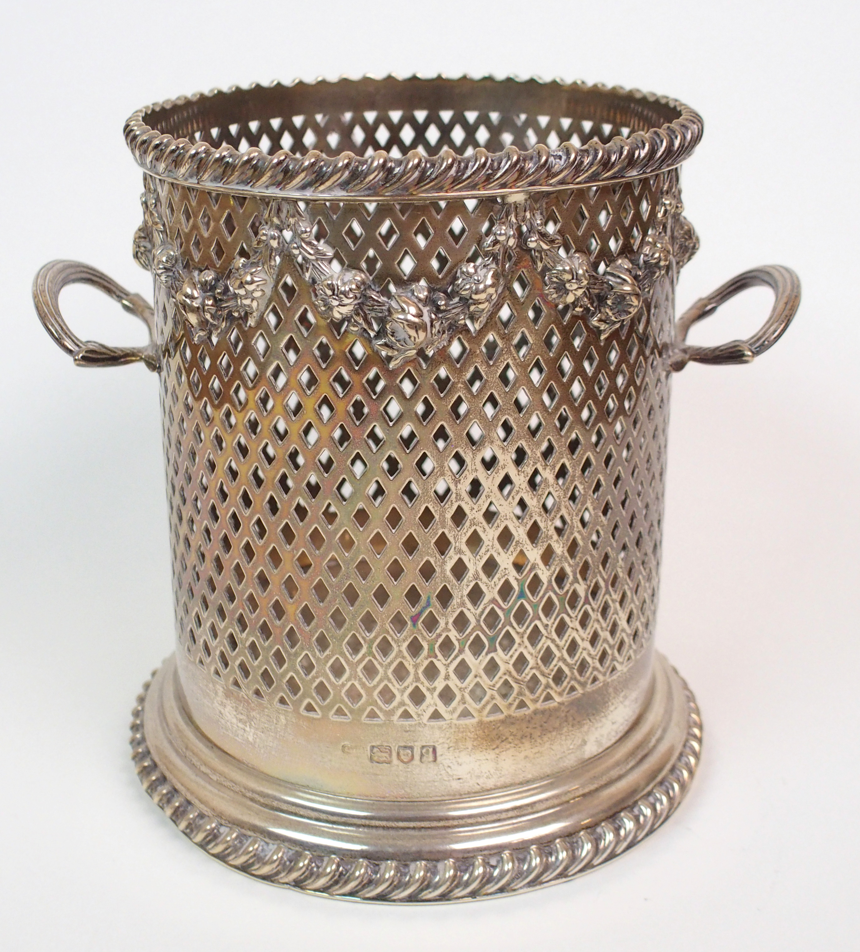 A GEORGE V SILVER BOTTLE STAND by Goldsmiths & Silversmiths Co., London 1911 of cylindrical form