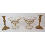 A PAIR OF GLASS COMPORTS with gilded metal stands, the glass painted with gilt swag decoration,