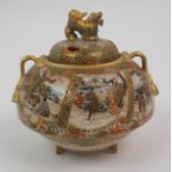 A SATSUMA KORO the pierced cover with shishi finial above panels of figures and ribbon tied handles,