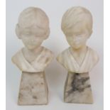 A PAIR OF ALABASTER BUSTS modelled as a boy and girl, upon spreading plinths, 22cm high (2)