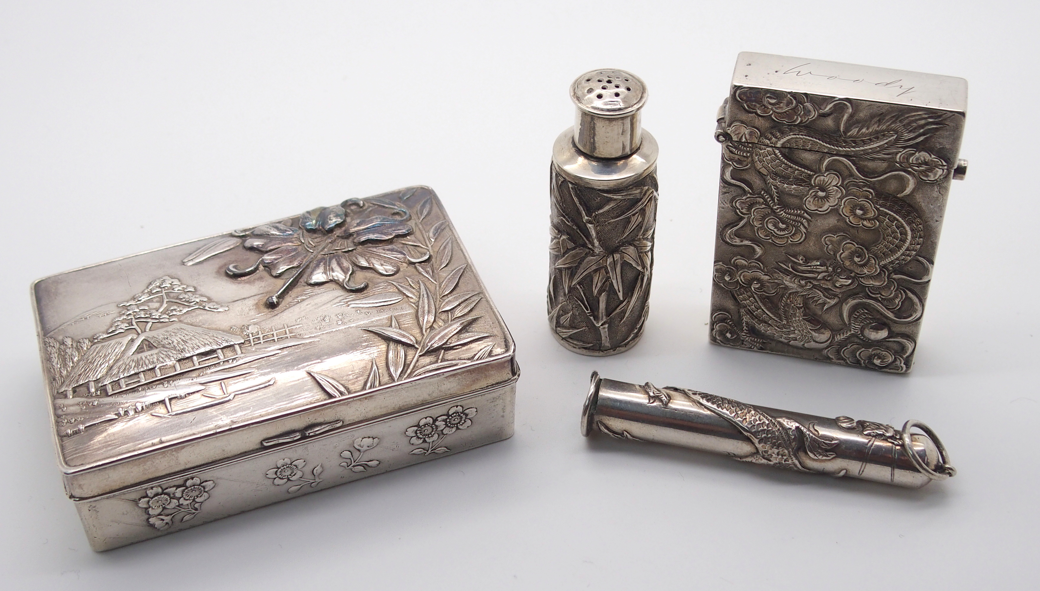 A CHINESE SILVER PEPPER CASTOR decorated with bamboo, stamped WH 90, 5.5cm high, white metal