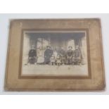 A CHINESE PHOTOGRAPH OF A FAMILY GROUP with eight adults and two children in an interior, 14cm x