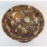 A SATSUMA BOWL painted with figures in a garden within gilt brocade border and pierced foliate