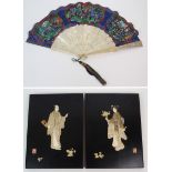 A PAIR OF LACQUERED AND ONLAID PANELS decorated in ivory and abalone shell with male and female