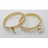 TWO BRIGHT YELLOW METAL AND PEARL BANGLES both with filigree and wire work detail, the pearls are