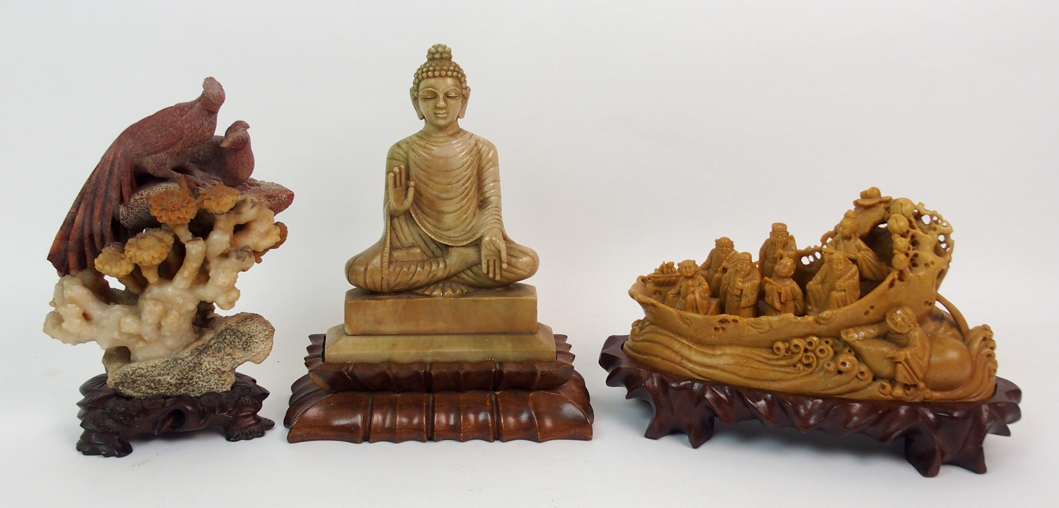 A CHINESE SOAPSTONE CARVING OF BUDDHA 17.5cm high, wood stand, peacock and hen on rockwork, 17cm