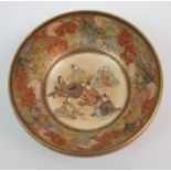 A SATSUMA BOWL painted with panels of figures, landscapes and flowers above a stiff leaf band,