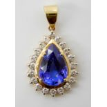 A TANZANITE AND DIAMOND PENDANT the tanzanite has a certificate from the Tokyo Gem laboratory,