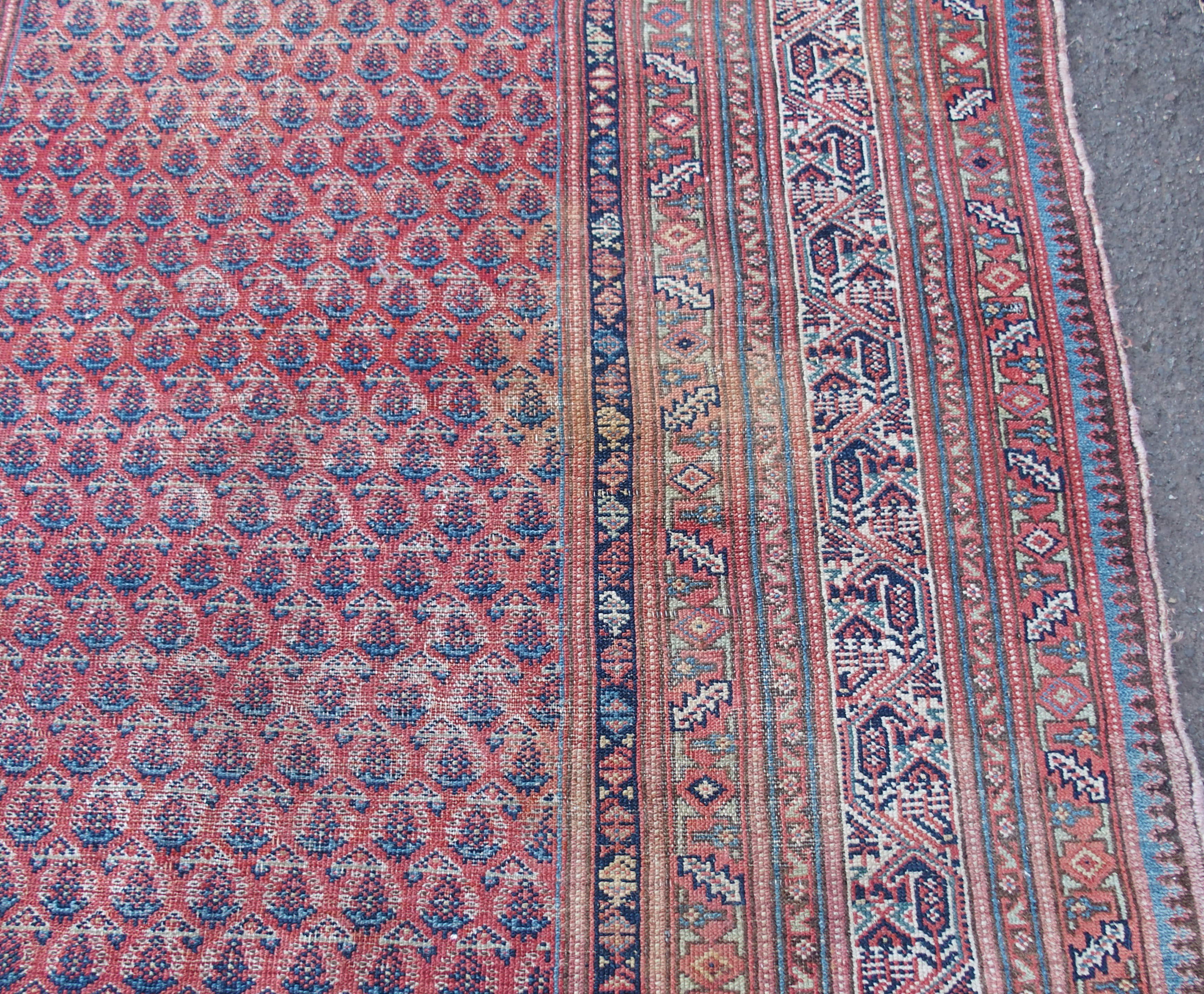 AN ARAAK RED GROUND RUG with multiple borders, 320cm x 150cm and an Eastern rug with four central - Image 4 of 10