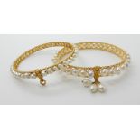 TWO BRIGHT YELLOW METAL AND PEARL BANGLES both with filigree and wire work detail, the pearls are