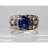 A SAPPHIRE AND DIAMOND DRESS RING set throughout in white metal, the approx dimensions of the oval