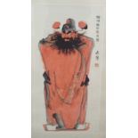 A CHINESE SCROLL PAINTING OF A MANDARIN standing in long flowing robes, signed, 109cm x 52cm (