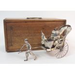 A CHINESE SILVER RICKSHAW CRUET of traditional type with salt, pepper and mustard pot, the carriage,