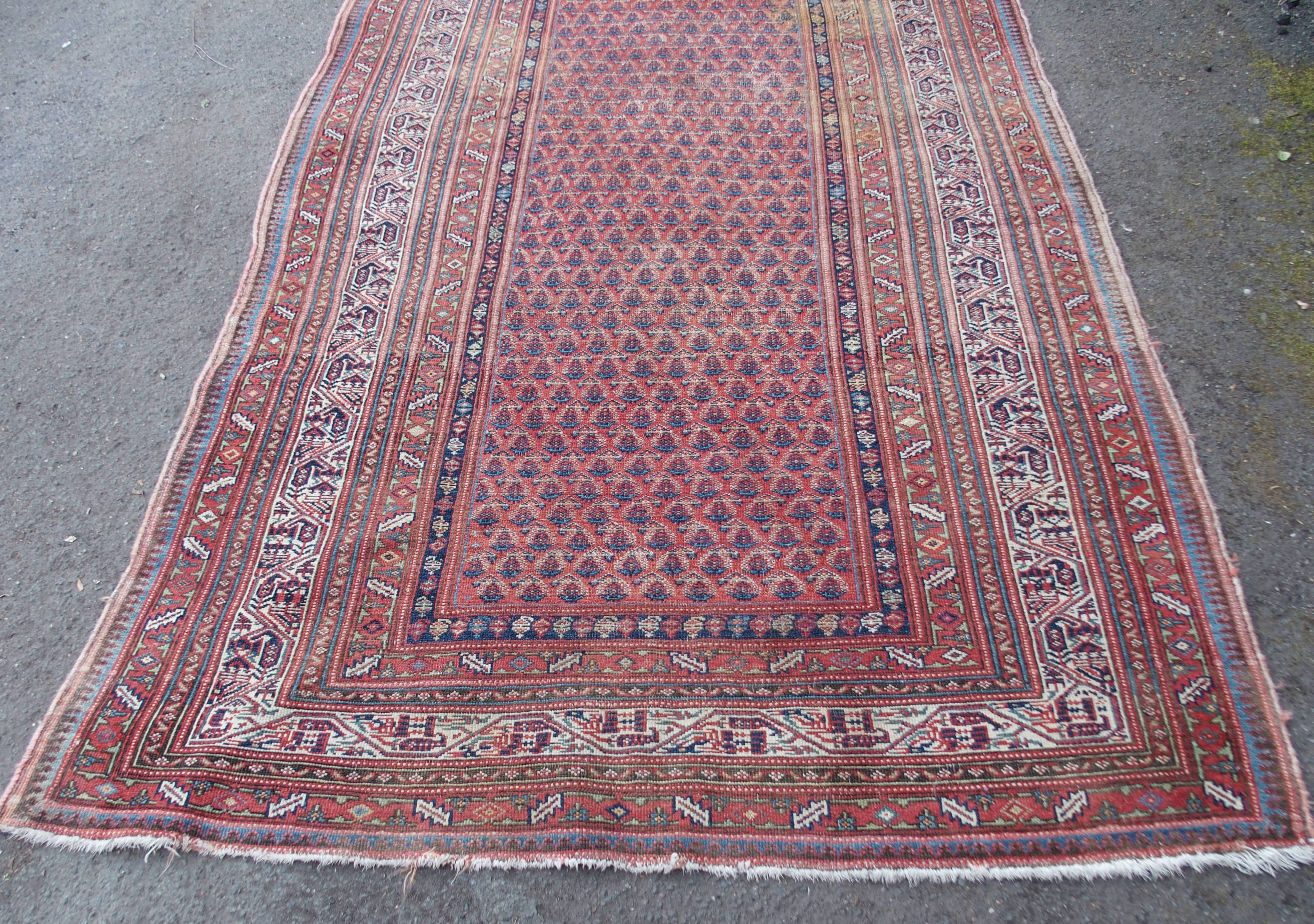 AN ARAAK RED GROUND RUG with multiple borders, 320cm x 150cm and an Eastern rug with four central - Image 3 of 10