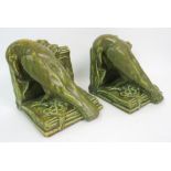 A PAIR OF ROOKWOOD (AMERICAN) POTTERY RAVEN BOOKENDS in mottled green glaze, impressed marks,