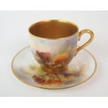 A ROYAL WORCESTER CABINET CUP AND SAUCER by Stinton, painted with cattle in a landscape, with