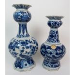 TWO ANTIQUE DELFT BLUE AND WHITE BOTTLE VASES one decorated with prunus type decoration, 31cm high