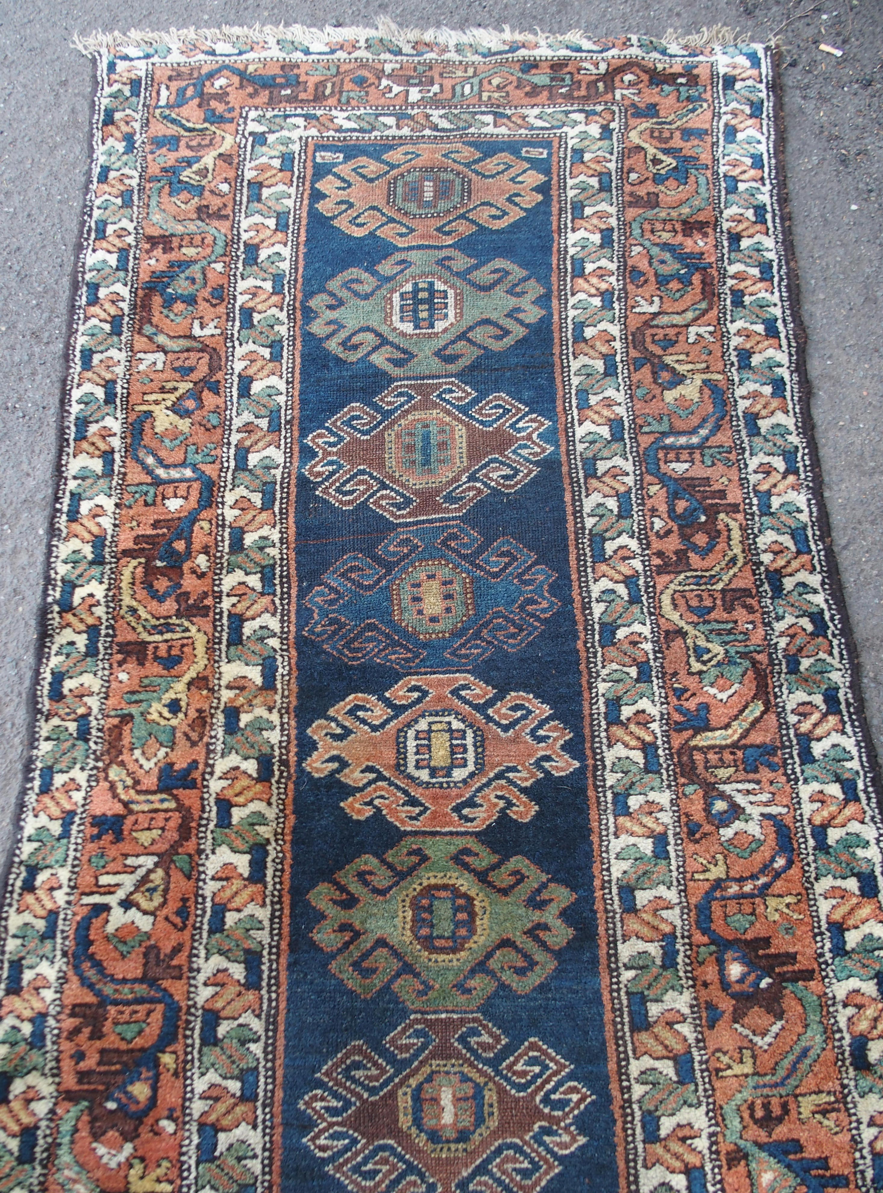 A CAUCASIAN BLUE GROUND RUNNER with nine central medallions and geometric border, 474cm x 96cm and - Image 9 of 10