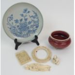 A CHINESE MONOCHROME CENSER on tripod bases, 11cm diameter, blue and white saucer, 18cm diameter,