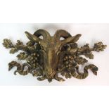 A LATE 19TH CENTURY GILT-BRONZE GOAT'S HEAD WALL PLAQUE decorated with bunches of grapes, oak leaves