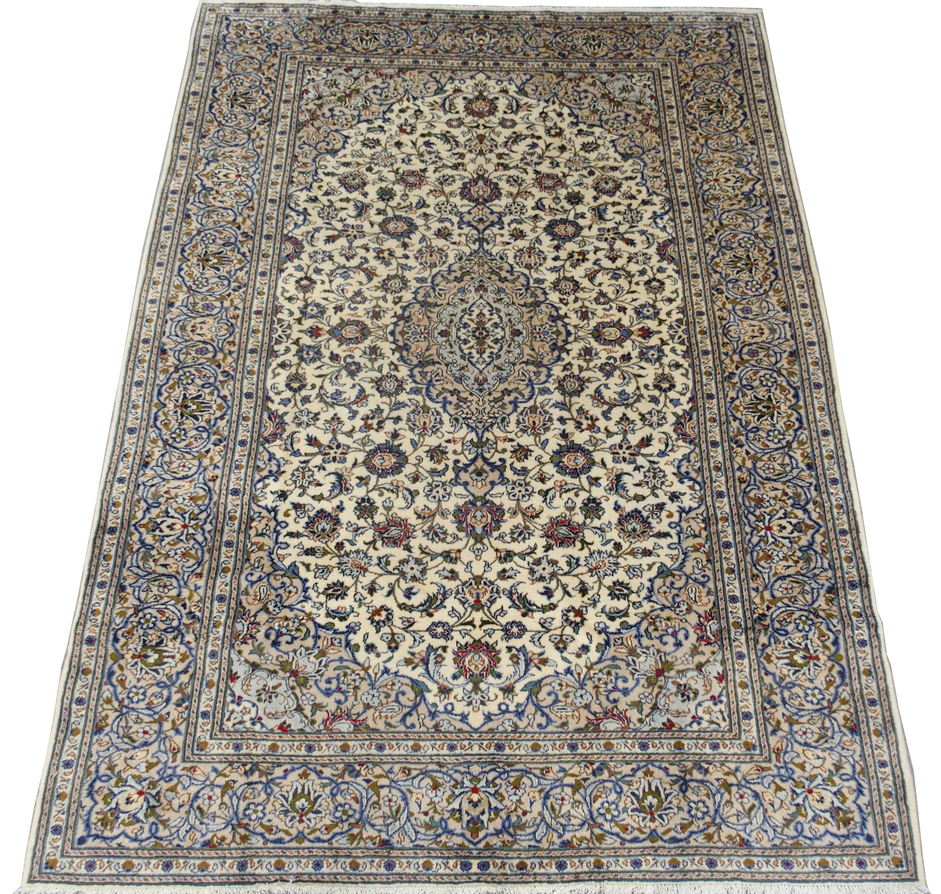 A CREAM GROUND KASHAN RUG with floral designs, central medallion and a border with floral palmettes,