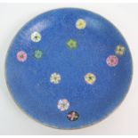 A CHINESE PORCELAIN DISH with incised scrolling and enamel foliage on a blue ground, blue seal mark,