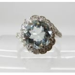A PLATINUM AQUAMARINE AND DIAMOND DRESS RING the dimensions of the aquamarine are approx 9.3mm x 5.