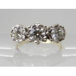 AN 18CT GOLD THREE STONE DIAMOND RING of estimated approx 0.60cts combined, in cut back star