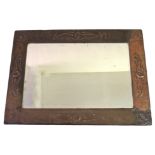 A GLASGOW SCHOOL ARTS AND CRAFTS COPPER FRAMED MIRROR of rectangular form, the hammered ground