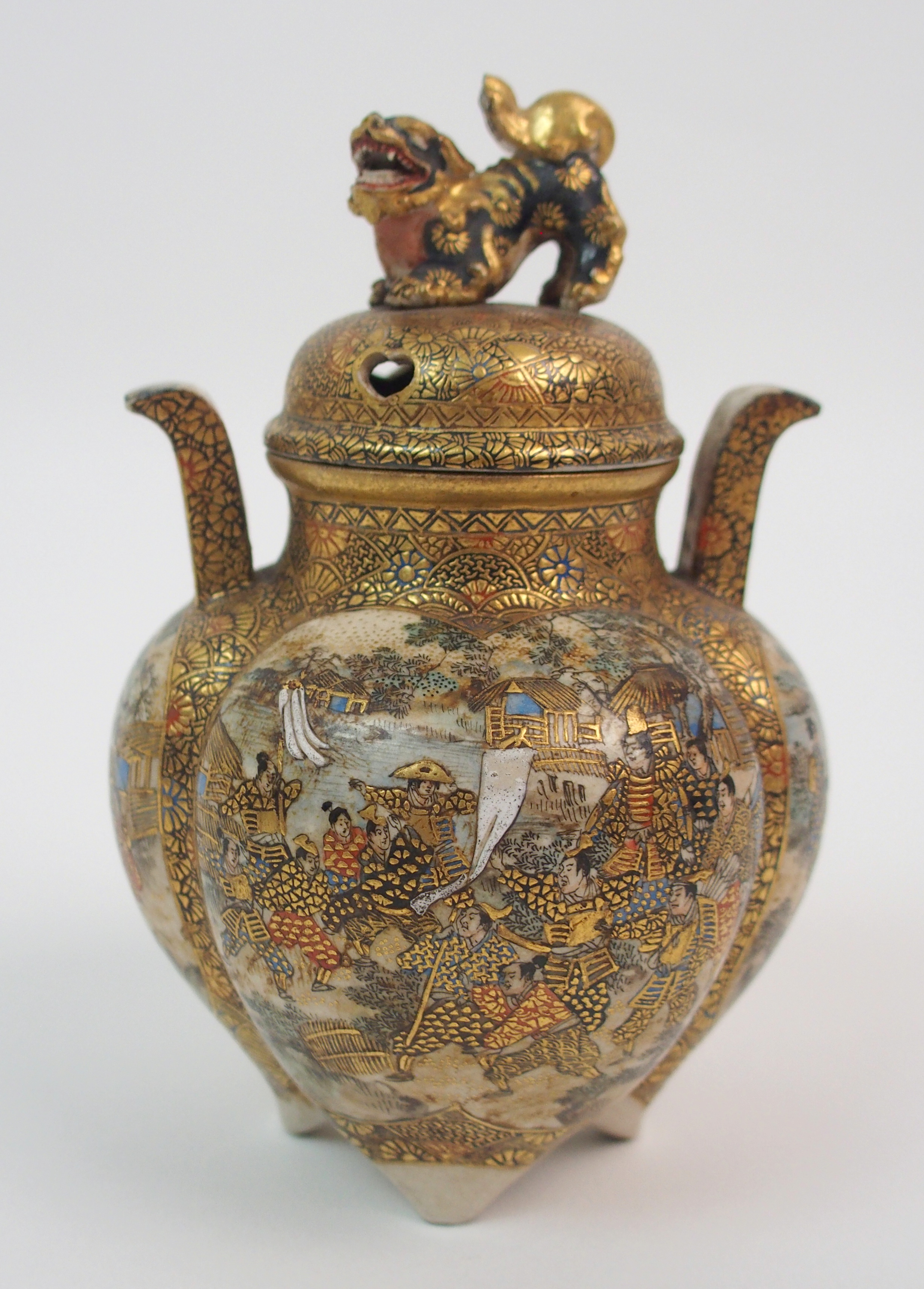 A SATSUMA KORO the cover with shishi finial above a quatrefoil lobed body painted with numerous