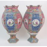 A PAIR OF CHINESE POLYCHROME HEXAGONAL LANTERN VASES painted and pierced with alternate panels of