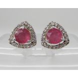 A PAIR OF RUBY AND DIAMOND EARRINGS set in white metal, to a triangular design, dimensions rubies