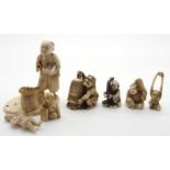 A JAPANESE IVORY OKIMONO ONI holding a temple bell enclosing another demon, 5cm high, a netsuke of a