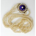 A FIVE STRAND FINE SEED PEARL NECKLACE with a blue enamel and pearl yellow metal clasp, 37cm at