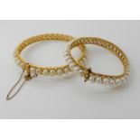 TWO BRIGHT YELLOW METAL AND PEARL BANGLES both with filigree and wire work detail, the pearls are