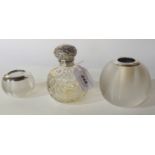 A lot comprising a silver topped scent bottle and two silver mounted match holder/strikers