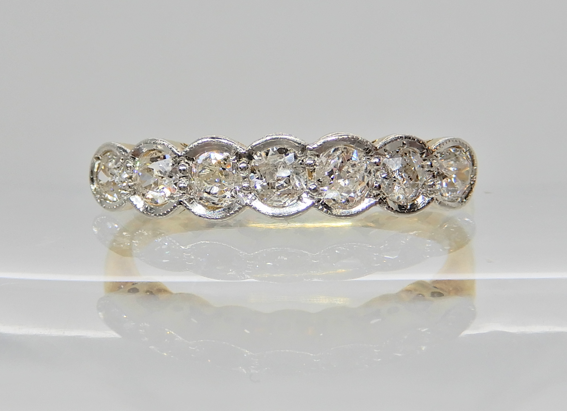 An 18ct gold and platinum seven stone diamond ring of estimated approx 0.75cts in total, finger size