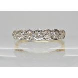An 18ct gold and platinum seven stone diamond ring of estimated approx 0.75cts in total, finger size