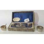 A lot comprising a silver plated desk set in fitted box and a pair of silver salts, London 1887