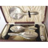 A cased six-piece silver dressing table set, Birmingham 1939