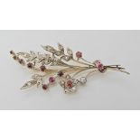 A ruby and diamond flower spray brooch, set with estimated approximately 0.40cts of diamonds.