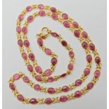 An 18ct gold chain spectacle set with rubies, length 44cm, weight 6.4gms