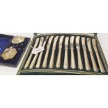 A lot comprising a cased set of twelve silver handled knives and a cased pair of silver salts,