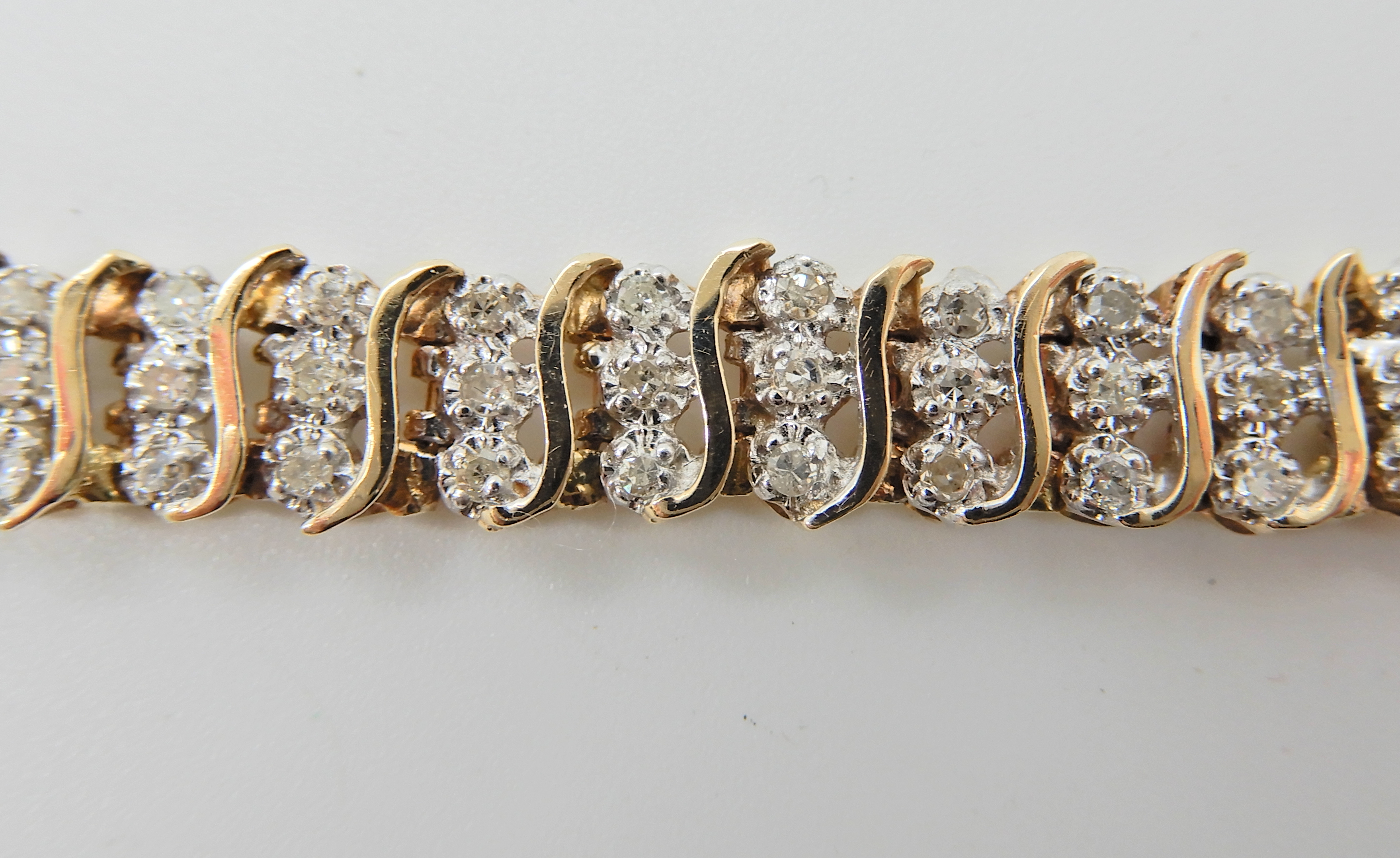 A 9ct gold diamond set bracelet, with 'S' shaped links, stamped 375 and the diamond content is - Image 3 of 4
