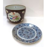 An oriental stoneware bowl decorated with floral panels and a blue and white plate (2), 21.5cm